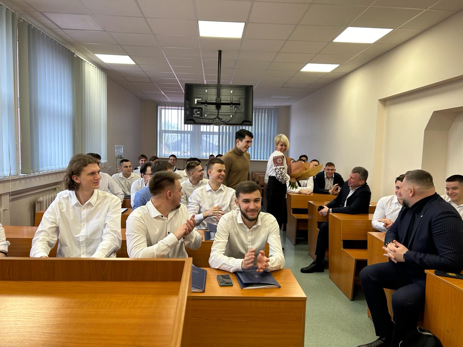 Ukrainian seafarer cadets laughing while seated in a classroom.